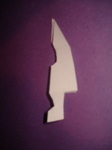 SnowflakeStep8 8. Cut the paper to make your snowflake. (For a hole in the center, cut the tip at the top.)